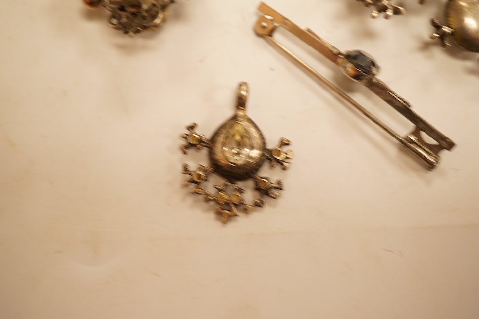 A late 19th/early 20th century Viennese pierced white metal, enamel and garnet cluster set brooch, 34mm, together with four other items of paste set jewellery.